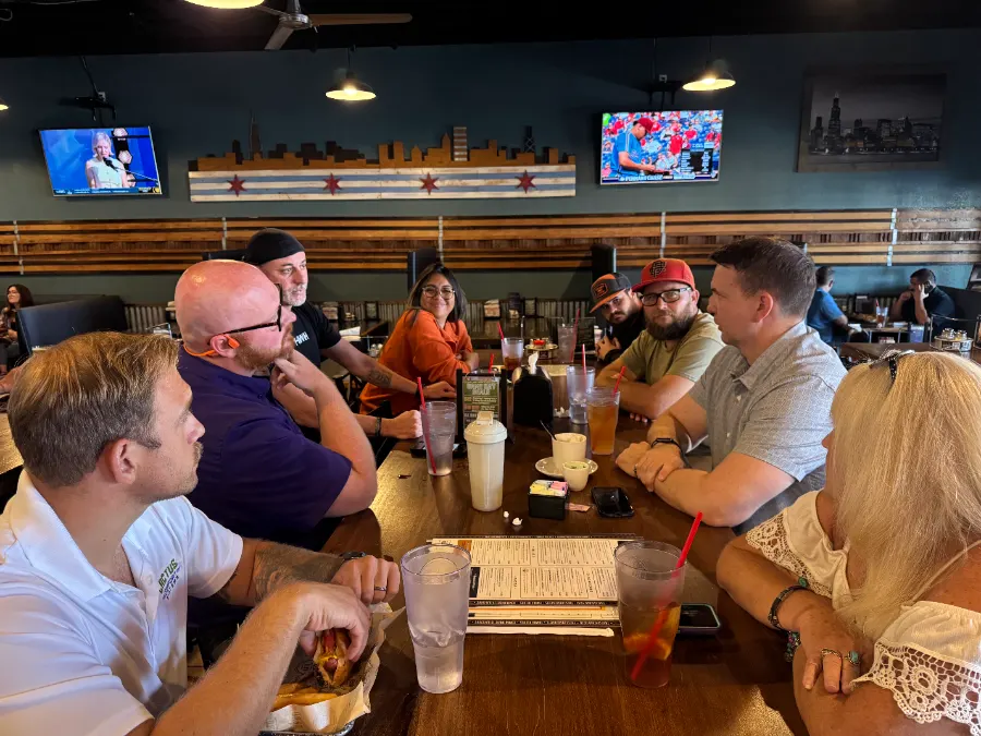 Trusted Team members talking around a lunch table at a TPC meeting